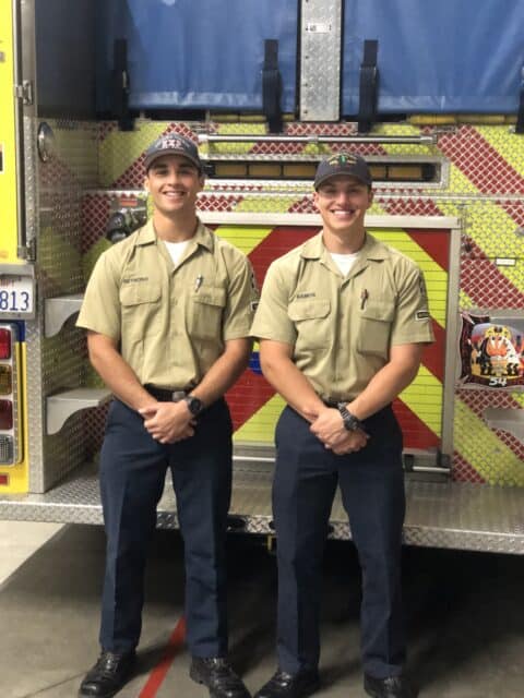 two explorers in front of a fire truck